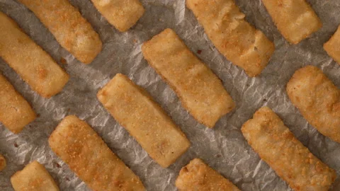 Fish sticks made from wild-caught Alaskan Pollock close-up on a baking pan Stock Footage 223381216