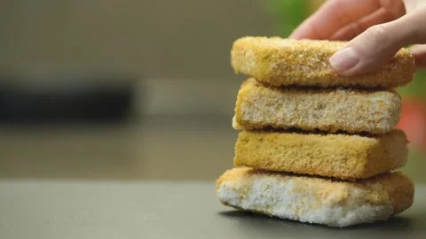 Fish sticks. The process of cooking fish sticks in a pan, close-up. Breaded fish Stock Footage 220366150