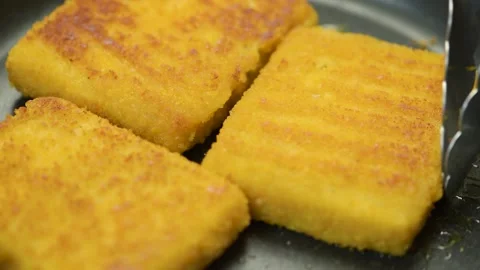 Fish sticks. The process of cooking fish sticks in a pan, close-up. Breaded fish Stock Footage 220366321