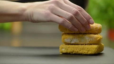 Fish sticks. The process of cooking fish sticks in a pan, close-up. Breaded fish Stock Footage 220366498