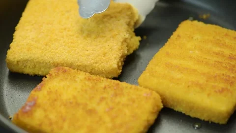 Fish sticks. The process of cooking fish sticks in a pan, close-up. Breaded fish Stock Footage 220520957