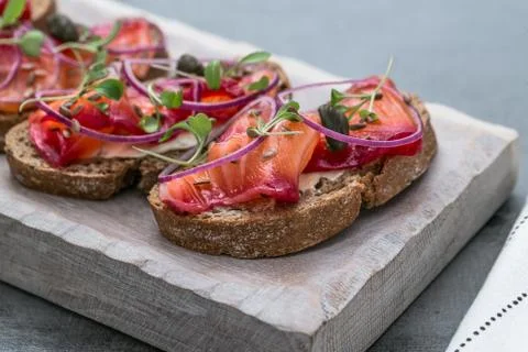 Fish Tapas on Crusty Bread, bread and cured salmon Stock Photos