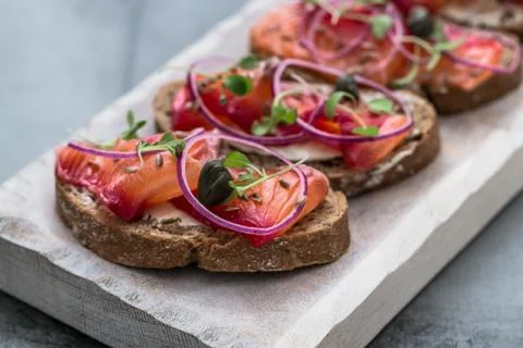 Fish Tapas on Crusty Bread, bread and cured salmon Stock Photos