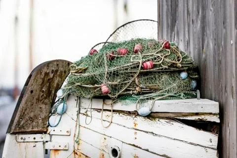 Fish trap on display on part of old wooden boat Stock Photos