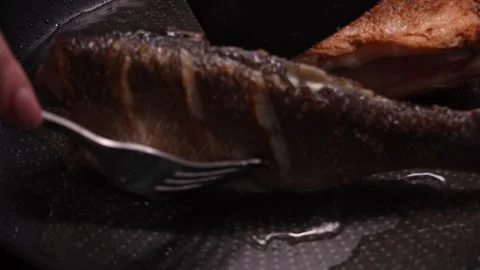 Fish is turned when pan frying. Stock Footage 258563080