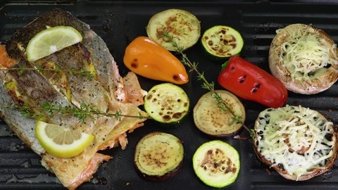 The fish with vegetables cooked on the grill, grilled salmon, top view, 4K Stock Footage 129716851