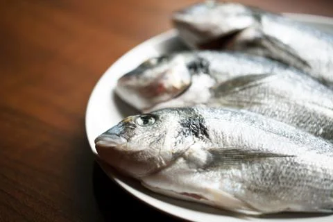 Fish on wooden background Stock Photos
