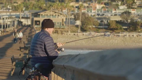 Fisher on a dock at sunset Stock Footage 88287380