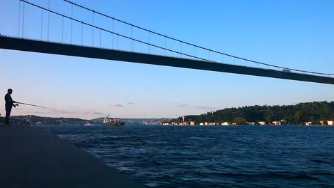 Fisher man under the Fatih Bridge, Istanbul, Turkey Stock Footage 113993572