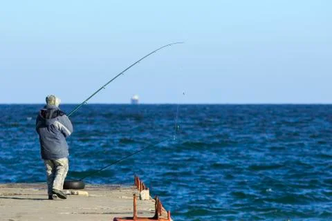 Fisher at the pier Foto stock