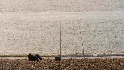 Fisher Sitting at Beach Stock Photos