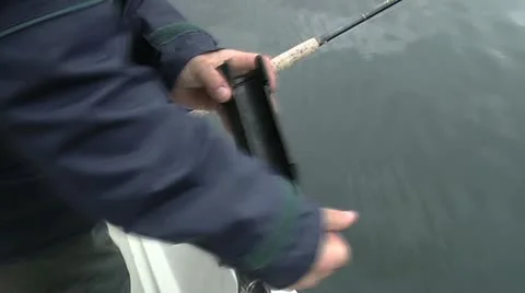 Fisherman adjust rod holder Stock Footage