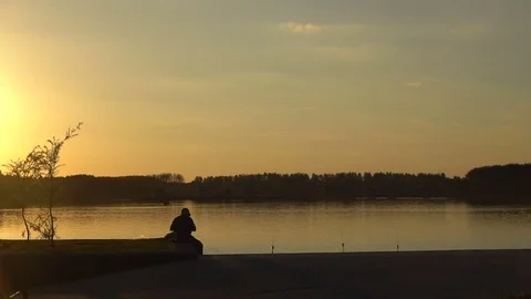 Fisherman and a group of cyclists 스톡 동영상 79631001