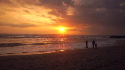 Fisherman and son on the beach at sunset Stock Footage 109124563