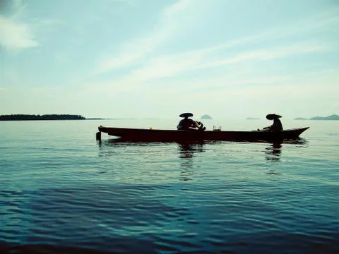 FISHERMAN ARE FISHING WITH TRADITIONAL BOATS Stock Photos