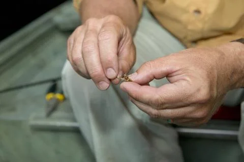 Fisherman baiting his hook Foto stock