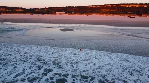 Fisherman battling the Waves during Sunset at Costa da Caparica beach, Portugal Stock Footage 145701987