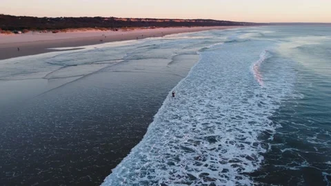 Fisherman battling the Waves during Sunset at Costa da Caparica beach, Portugal Video stock 145702029