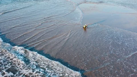 Fisherman battling the Waves during Sunset at Costa da Caparica beach, Portugal Stock Footage 145974941