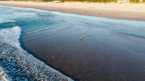 Fisherman battling the Waves during Sunset at Costa da Caparica beach, Portugal Stock Footage 145974949