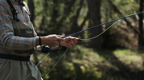 Fisherman casting with fly rod Stock Footage 51680370