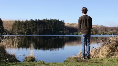 Fisherman casting into a lake Stock Footage 73525159