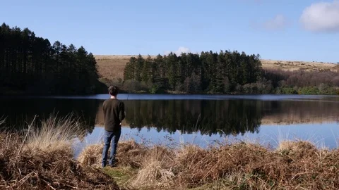 Fisherman casting into a lake Stock Footage 73525194