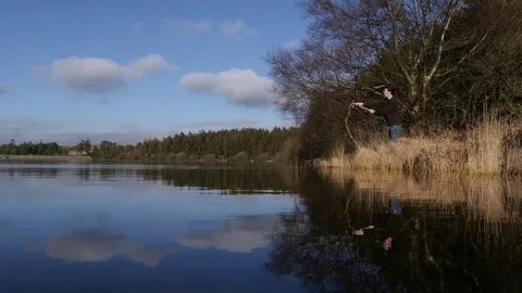 Fisherman casting into a lake Stock Footage 73526081