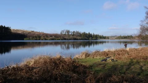 Fisherman casting into a lake, wide 스톡 동영상 73526140
