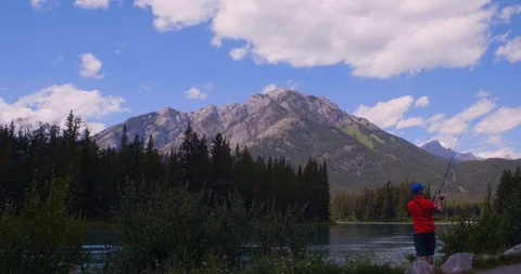Fisherman casting a lure into a river Banff Canadian rocky mountains slow motion 스톡 동영상 123144241
