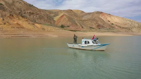 Fisherman Casting Net From Boat On Dam Lake, August 20,2021, Akincilar Sivas Stock Footage 324696069