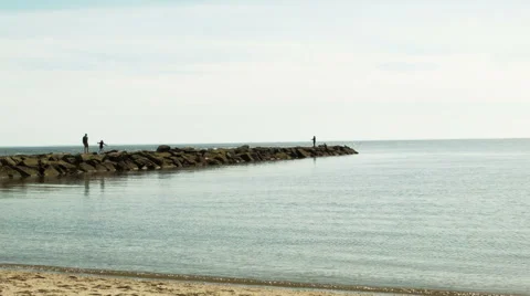 Fisherman casts off end of peninsula Stock Footage 49934840