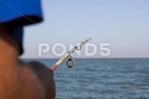 Fisherman catches a fish on a spinning Stock Photos