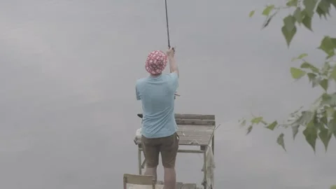 A fisherman is catching a fish Stock Footage 245310423