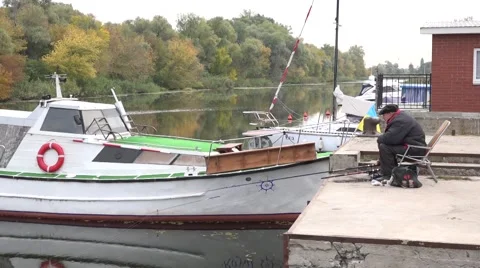 A fisherman caught a fish and pulled it to the shore. A good catch. Stock Footage 68714043