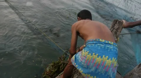 Fisherman cleans net Stock Footage 10594513