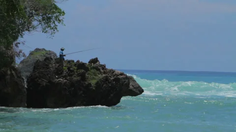 FISHERMAN ON CLIFF BY THE OCEAN Stock Footage 27331854