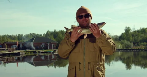 The fisherman demonstrates the caught pike Video stock 154944904
