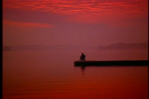 Fisherman on dock at sunset 1 Stock Footage 492942