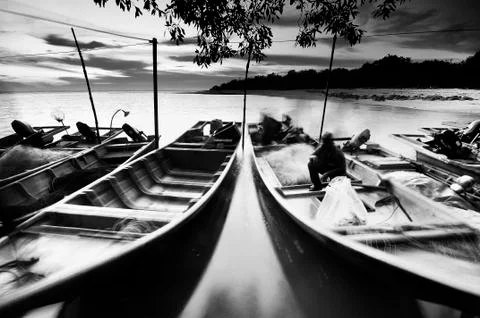 Fisherman docks floating on water at sunset in black and white Stock Photos
