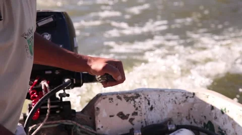 Fisherman driving small fishing motor boat on a river Stock Footage 62874026