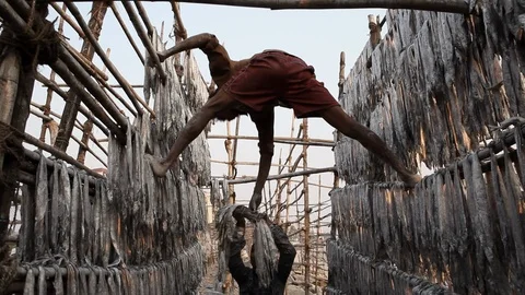 Fisherman is drying fish at Versova Beach in Mumbai, India. Stock Footage 87286446