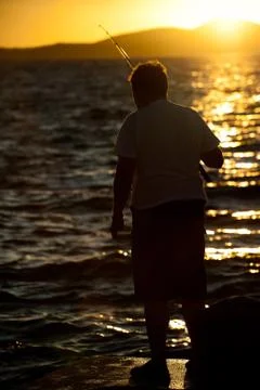 Fisherman at dusk Stock Photos