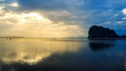 Fisherman finding shell on reflected beach at sunset Stock Photos