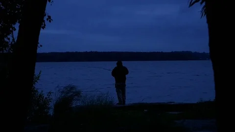 Fisherman Fishing At Night Stock Footage