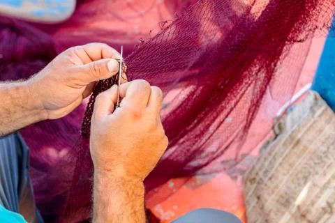 Fisherman is fixing the fish net Stock Photos