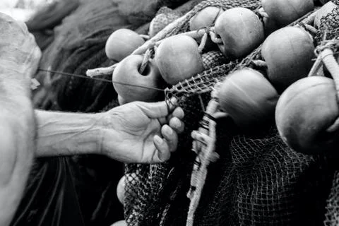 Fisherman is fixing the fish net Stock Photos