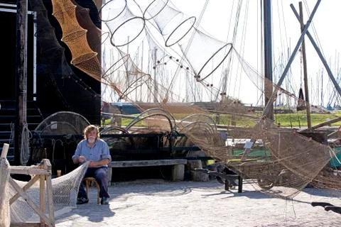 Fisherman fixing his nets Фото