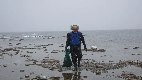 Fisherman With A Full Grid Of Seafood Is On The Beach In Winter Stock Footage 92080024