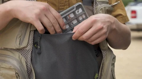Fisherman Getting Ready Packing Flys into Vest Stock Footage 122104150